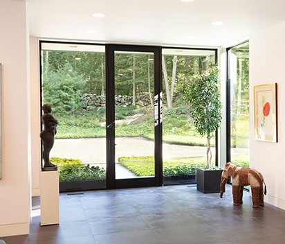 Hinged door features an optional concealed overhead closure 